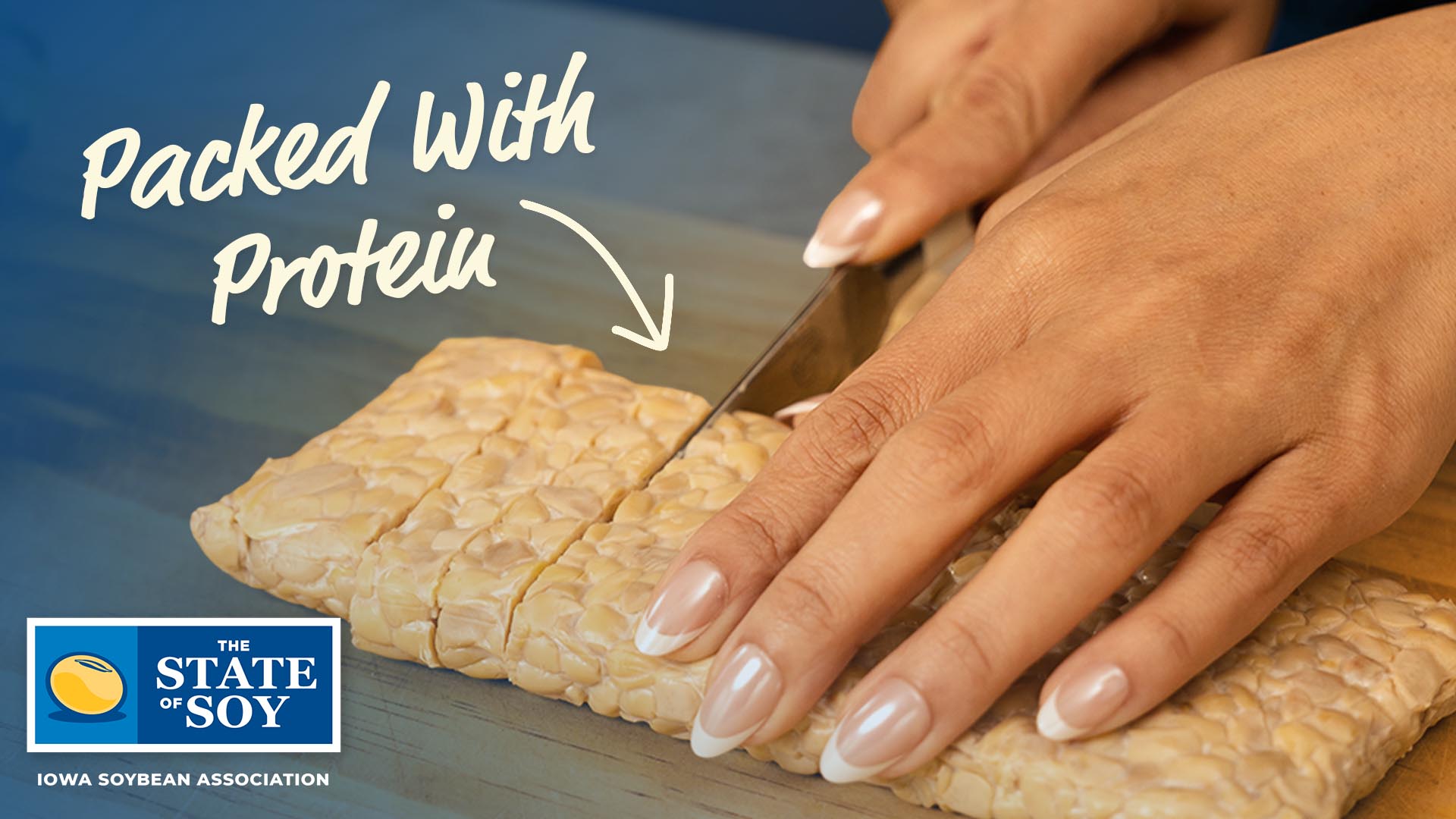 Tempeh getting cut with knife in kitchen