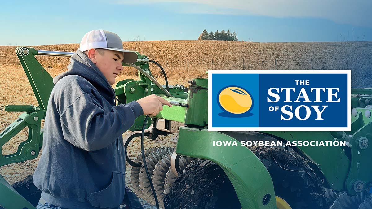 FFA member greasing farm equipment in Iowa
