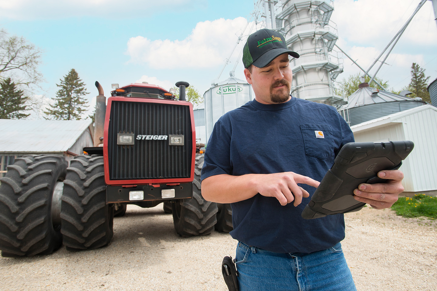 Iowa soybean farmers completing survey on his iPad