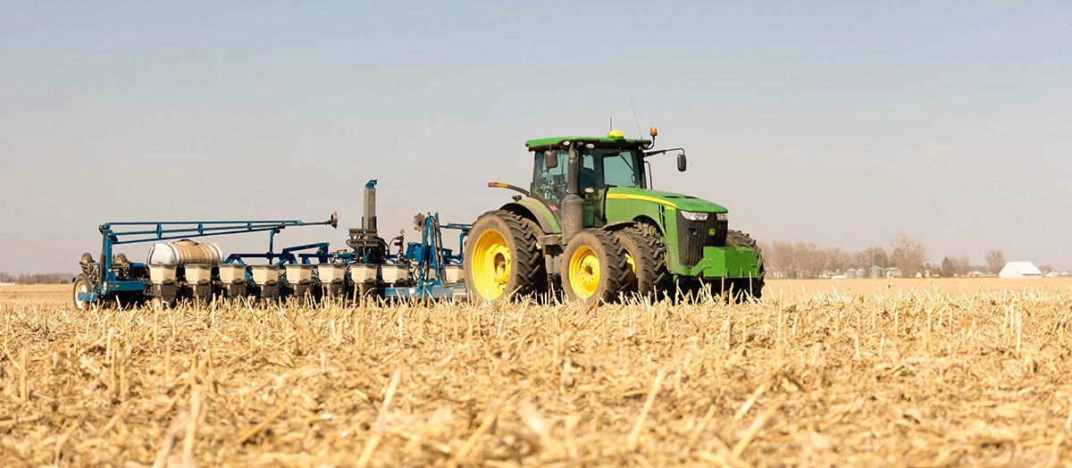 Lowering Carbon Intensity John Deere tractor pulling Kinze planter in Iowa