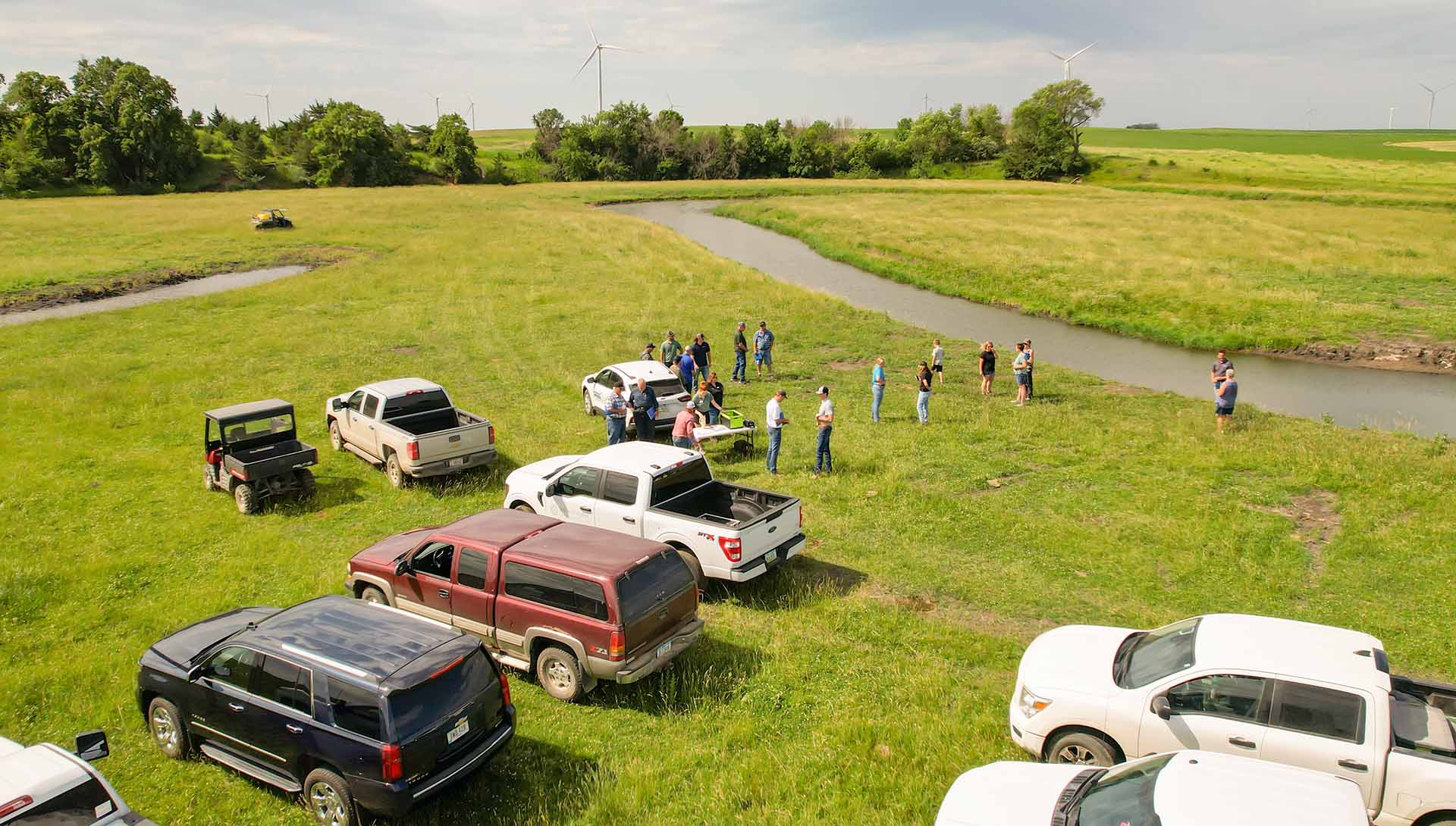 Farmers in field with agronomists near oxbow