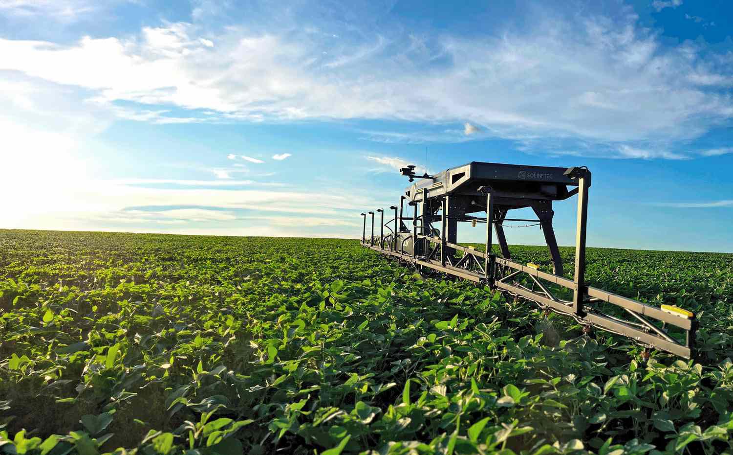 Autonomous sprayer going through soybean field