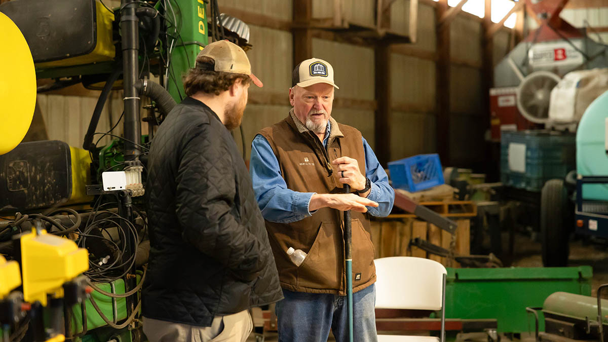 Farmer speaking with another farmer about his cropping practices
