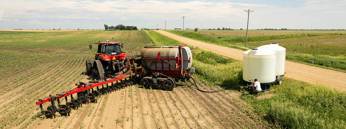 Red tractor sidedressing