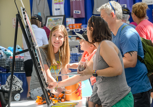 Iowa State Fair-goers engage with the Iowa Food & Family Project volunteers in the Varied Industries Building. 